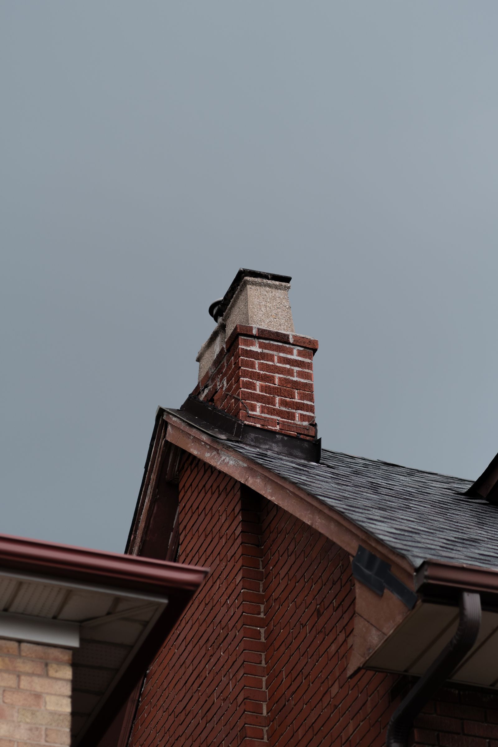 Brick chimney on a residential roof
