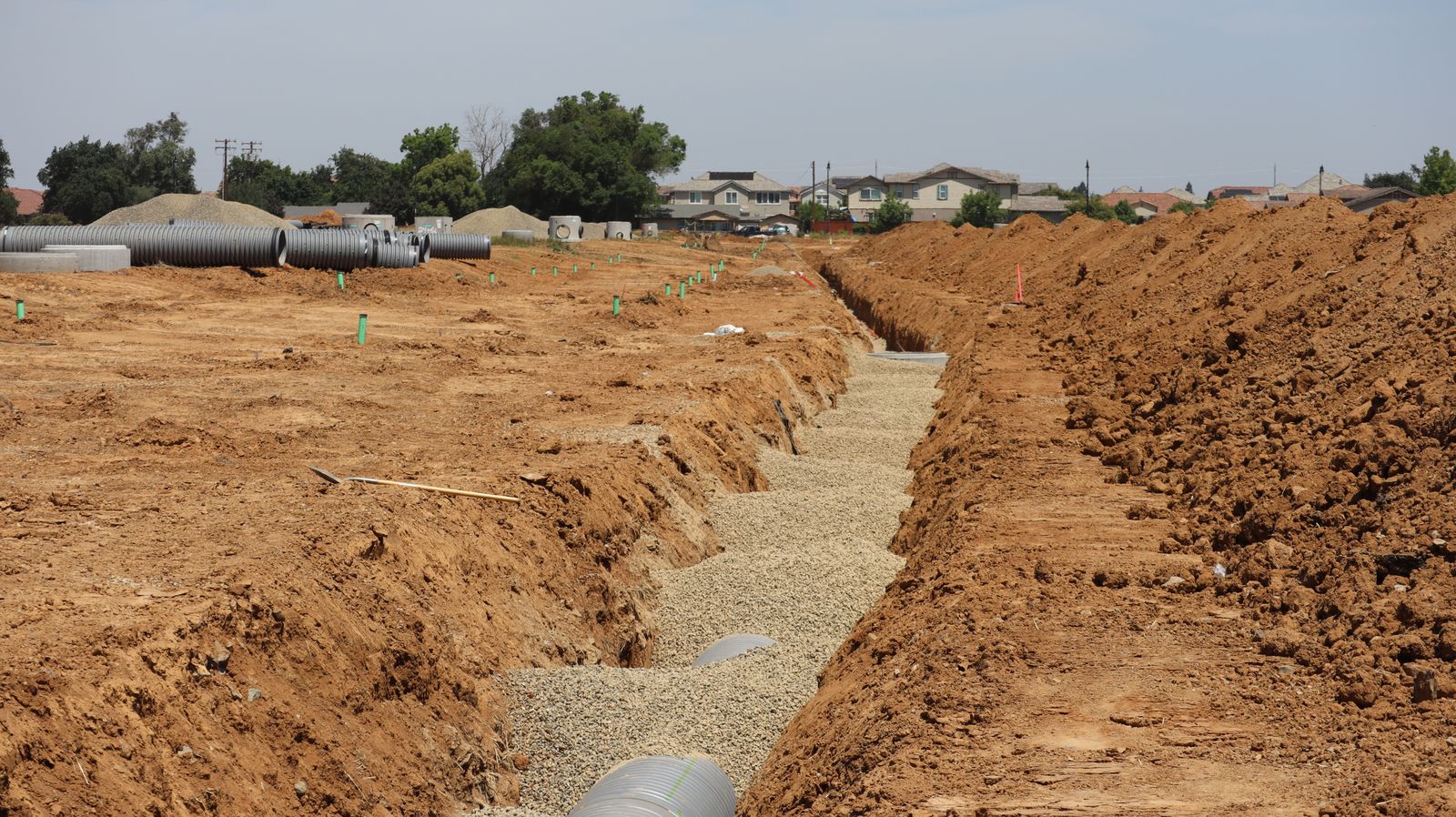 Open drainage trench with pipe bedded in gravel