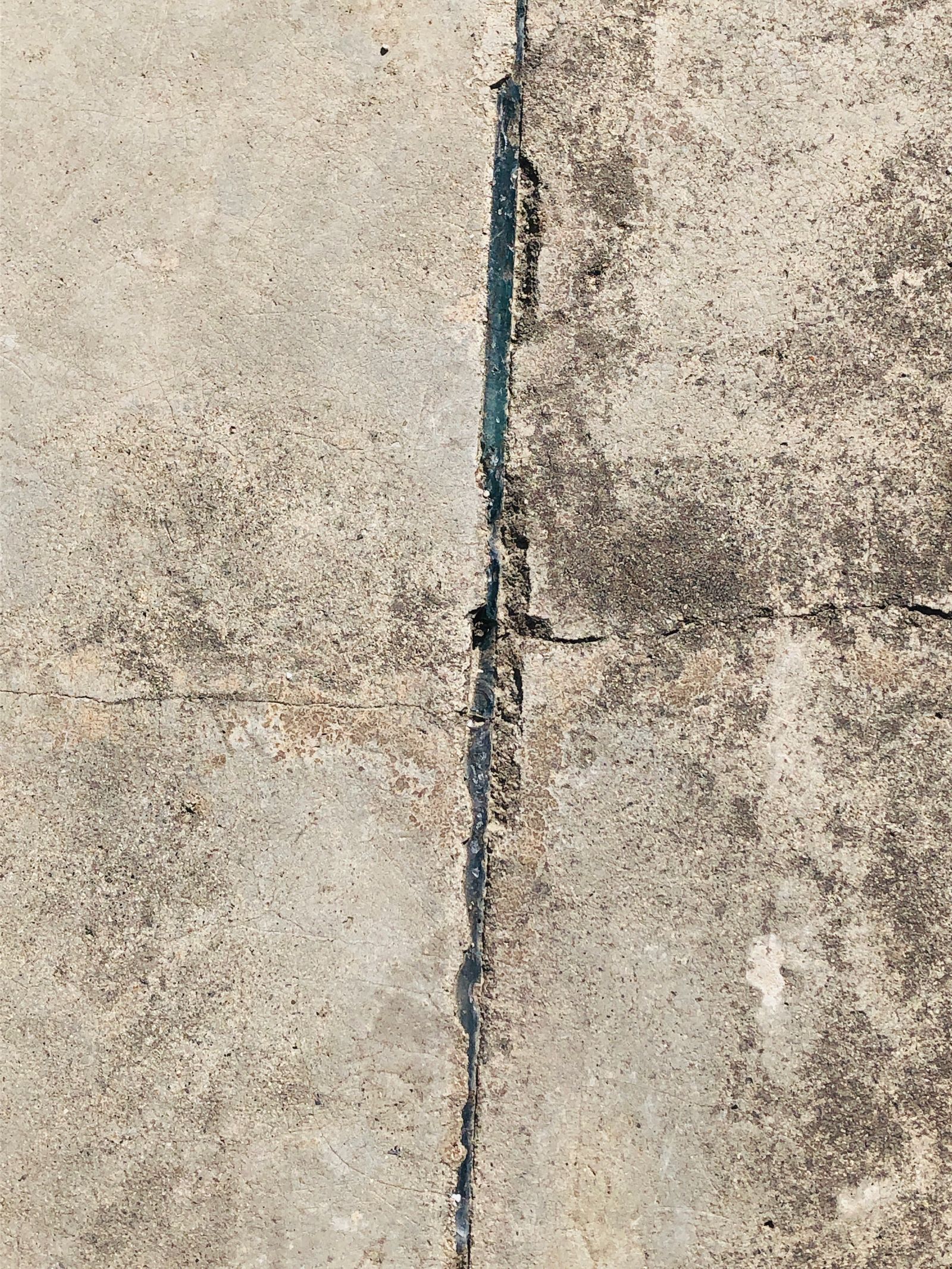 A structural crack running through a concrete foundation wall