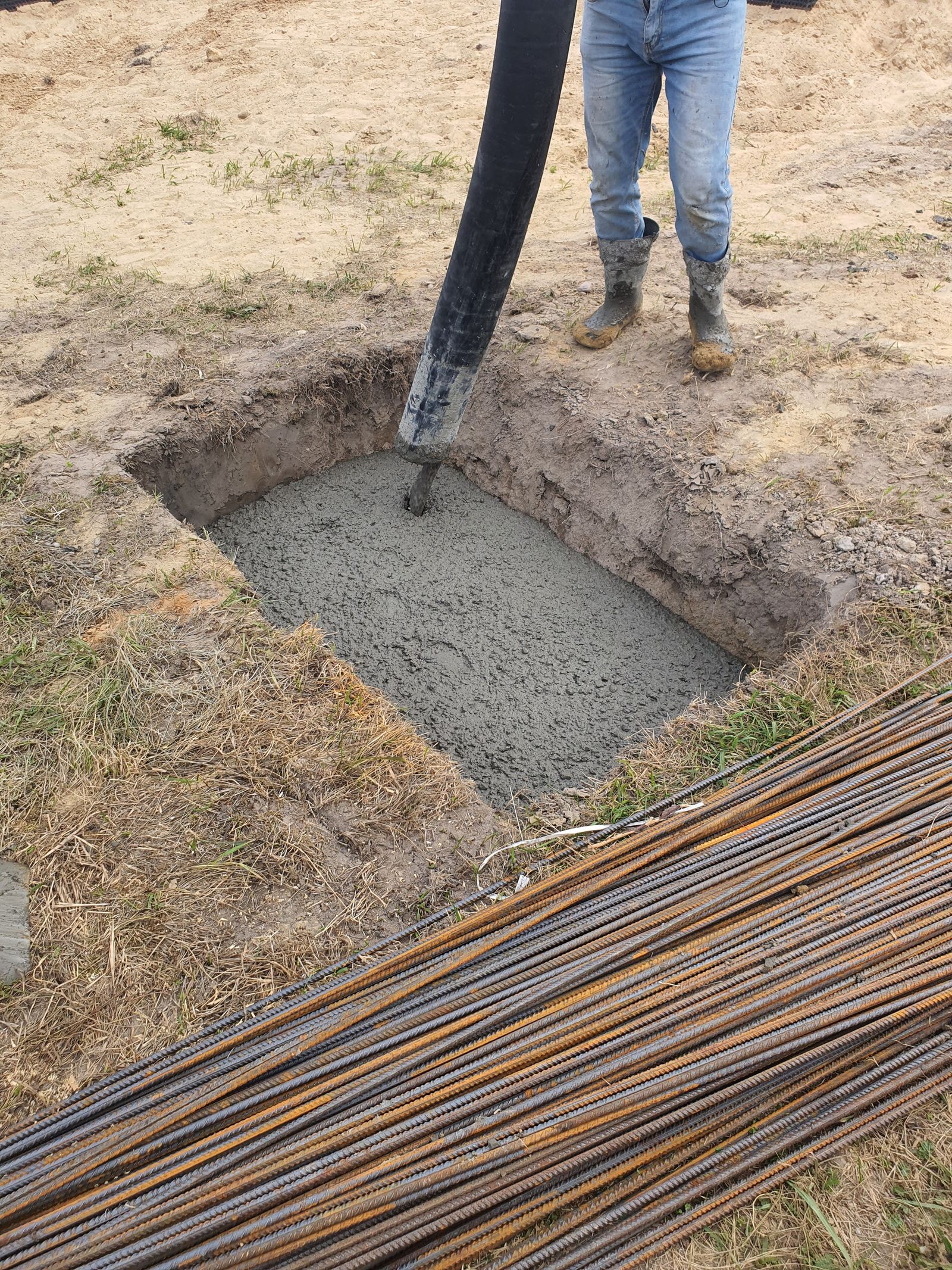 Concrete being placed into a foundation excavation