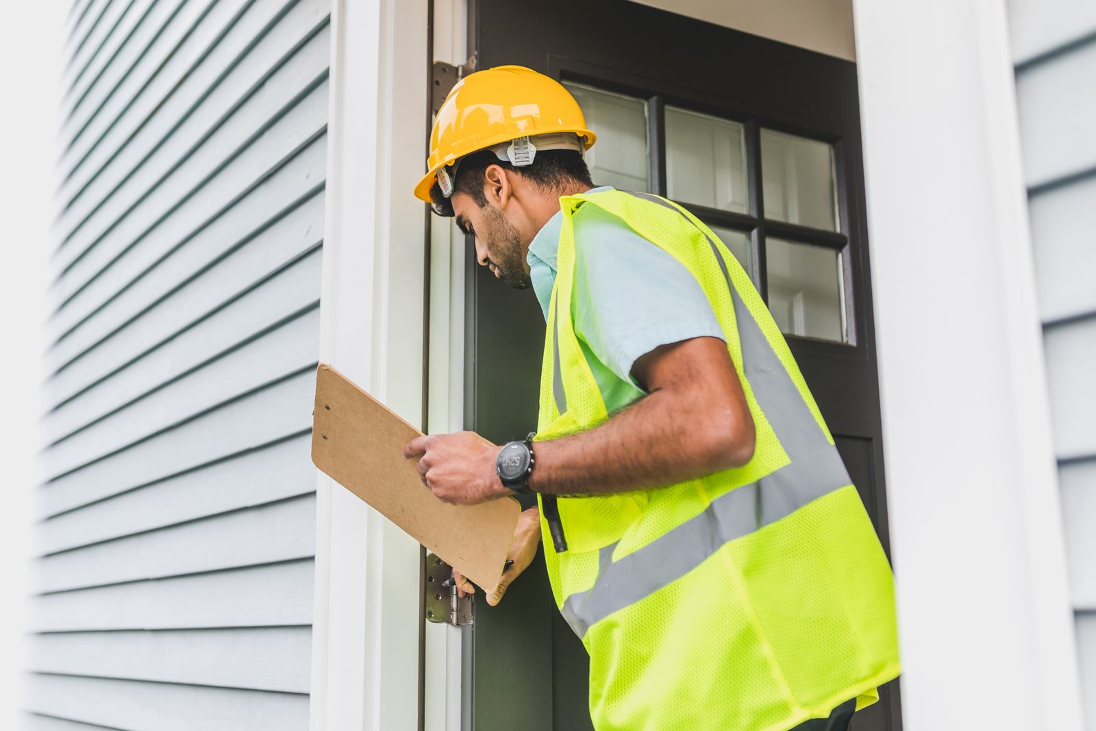 Contractor reviewing the exterior of a home